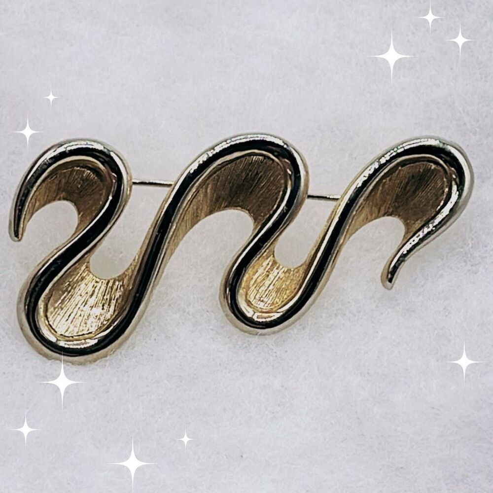 Vintage Monet ribbon wave brooch.